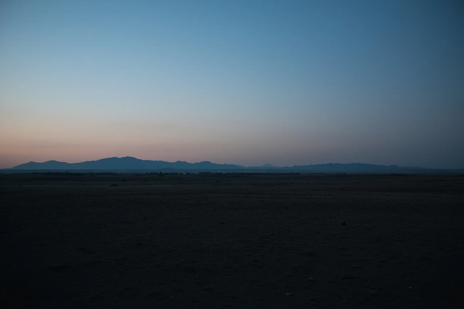 Missing Legendary Treasures That Are Yet to Be Found 17 A vast Mongolian steppe landscape at dusk with distant mountains and no visible structures, evoking a hidden tomb
