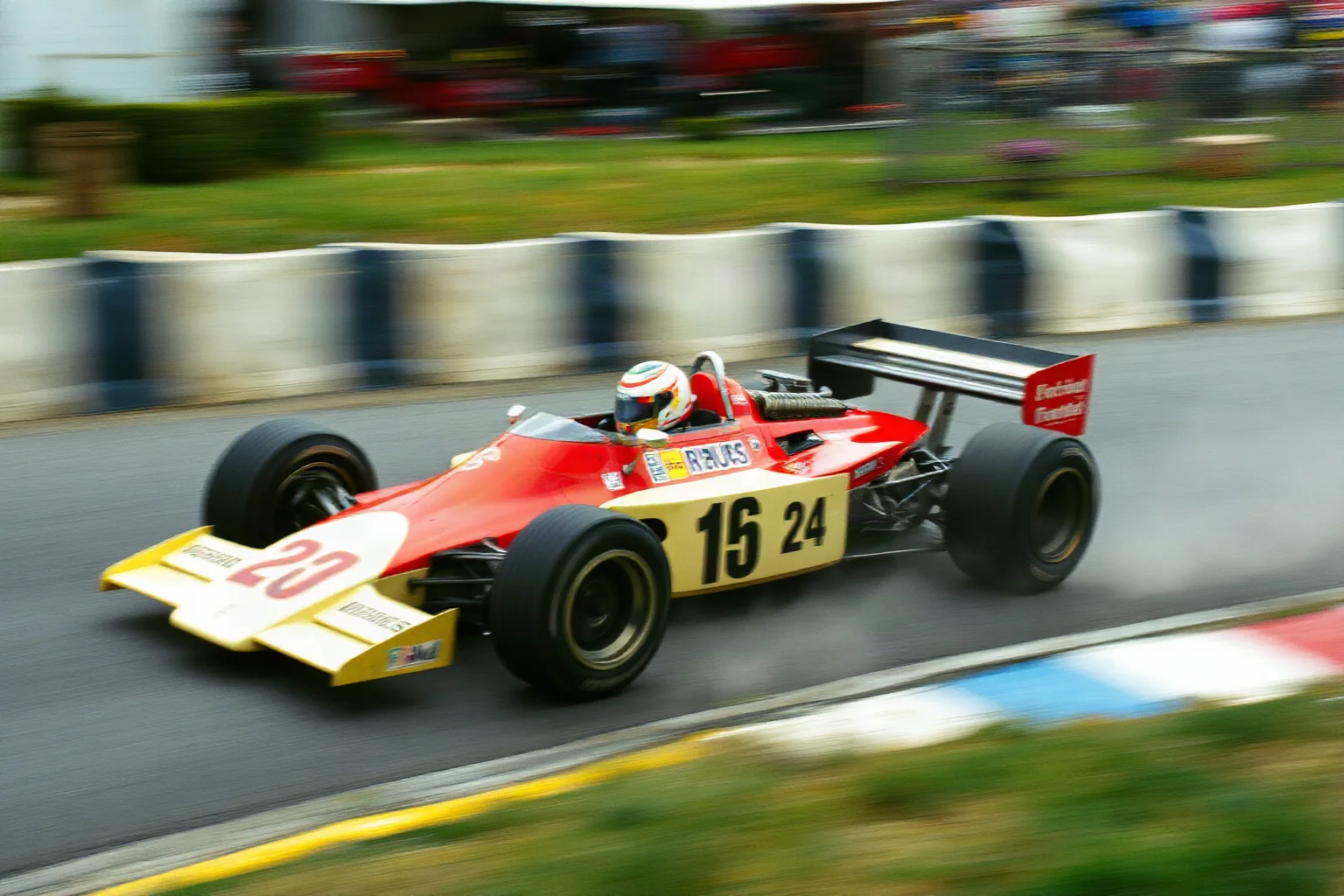 A vintage Formula 1 race car speeding around a European circuit in the 1970s, dramatic motion blur, retro racing aesthetic