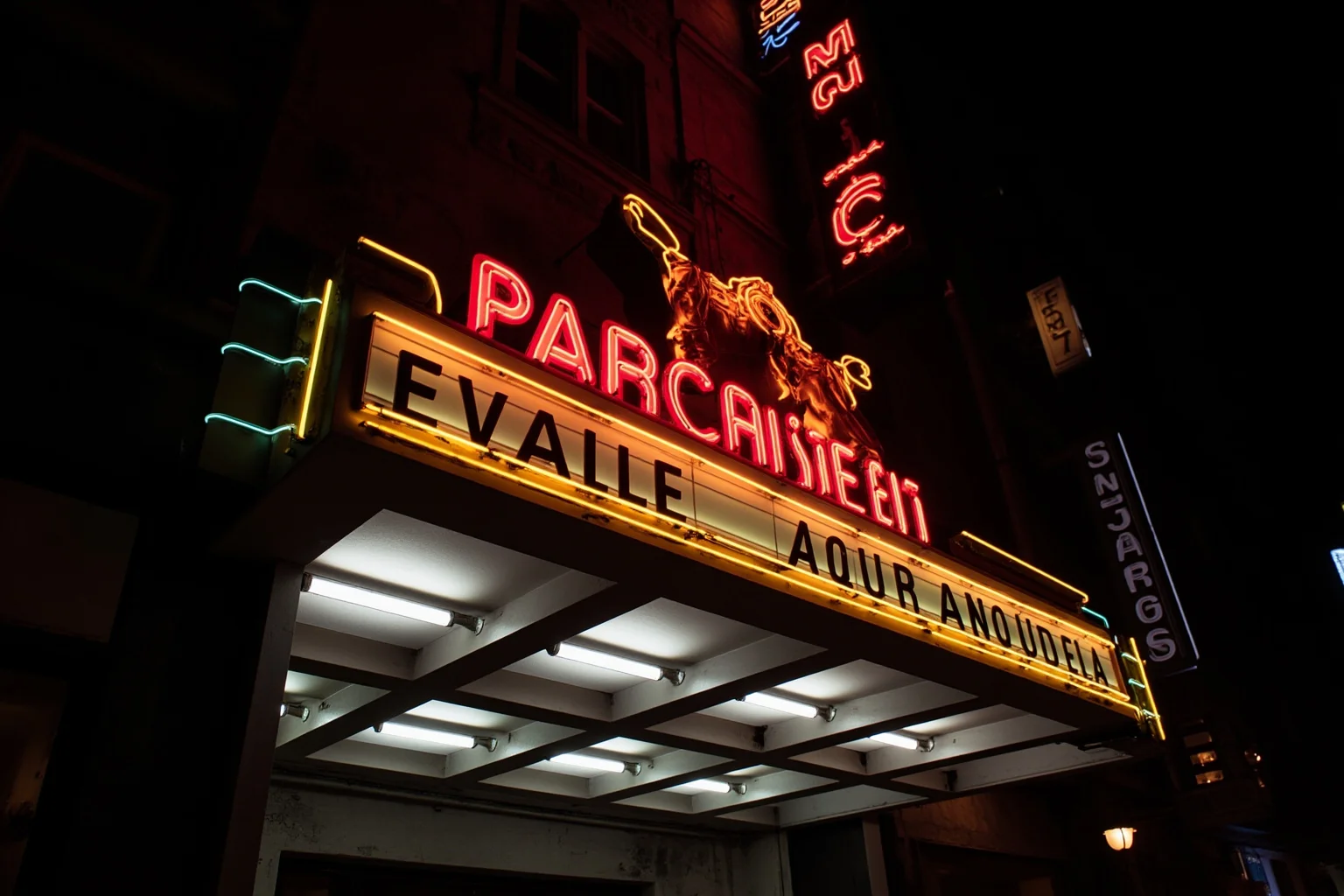 A vintage neon marquee sign glowing at night, evoking classic rock and roll era entertainment