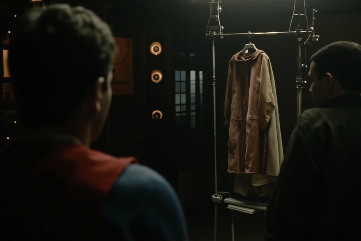22 Hollywood Stars Whose Lives Ended in Tragedy 23 A vintage television studio set with an old Superman-style cape hanging on a rack, dim lighting, evoking classic TV era tragedy