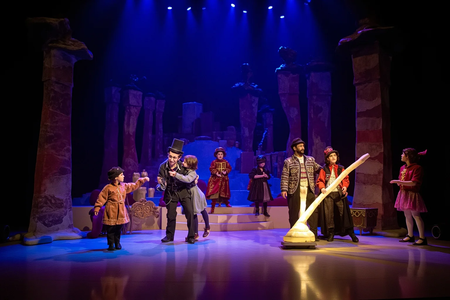A whimsical fairy-tale opera stage set with fantastical costumes and a glowing magical flute prop