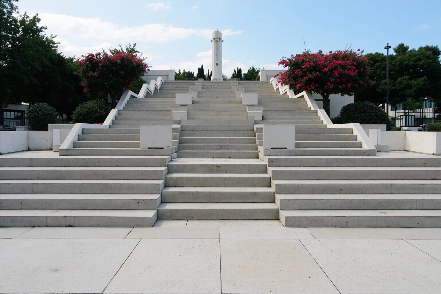 A wide outdoor concrete staircase leading up from a plaza, preserved as part of a modern memorial site