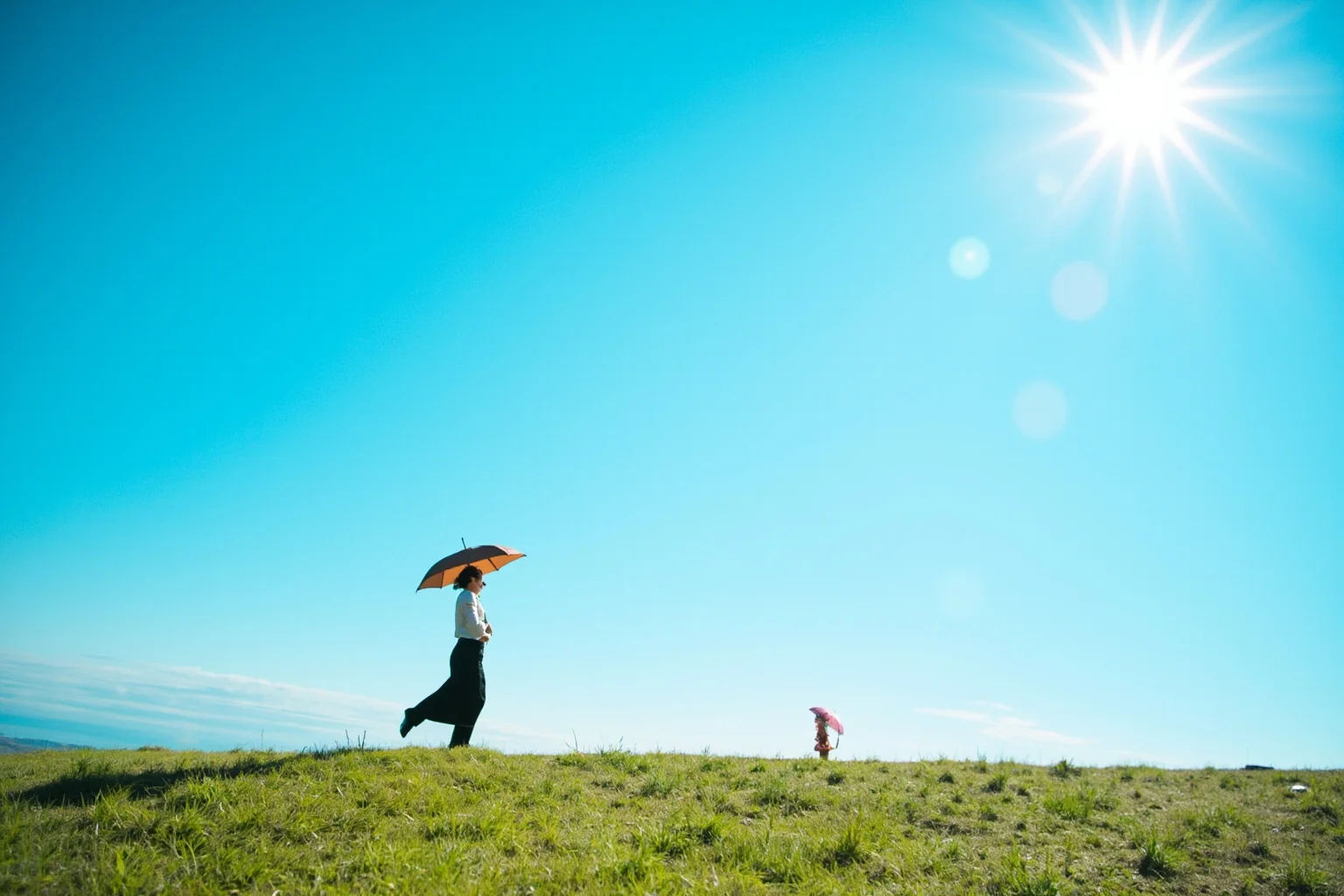 Amazing Facts About Claude Monet: His Life and 10 Greatest Paintings 13 A woman with a parasol standing on a grassy hillside under a bright blue sky with a small child nearby