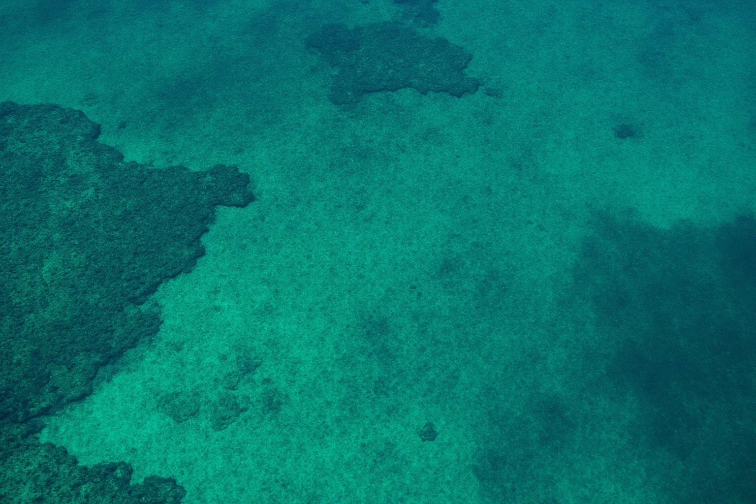 22 Coolest Underwater Discoveries Made Throughout History 5 Aerial view of a Bronze Age submerged town with visible street layouts beneath shallow turquoise water