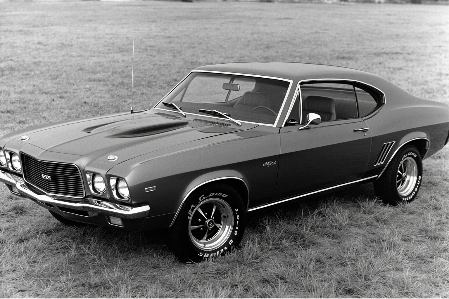 An aggressive fastback muscle coupe from the late 1960s with a wide chrome grille and quad headlights