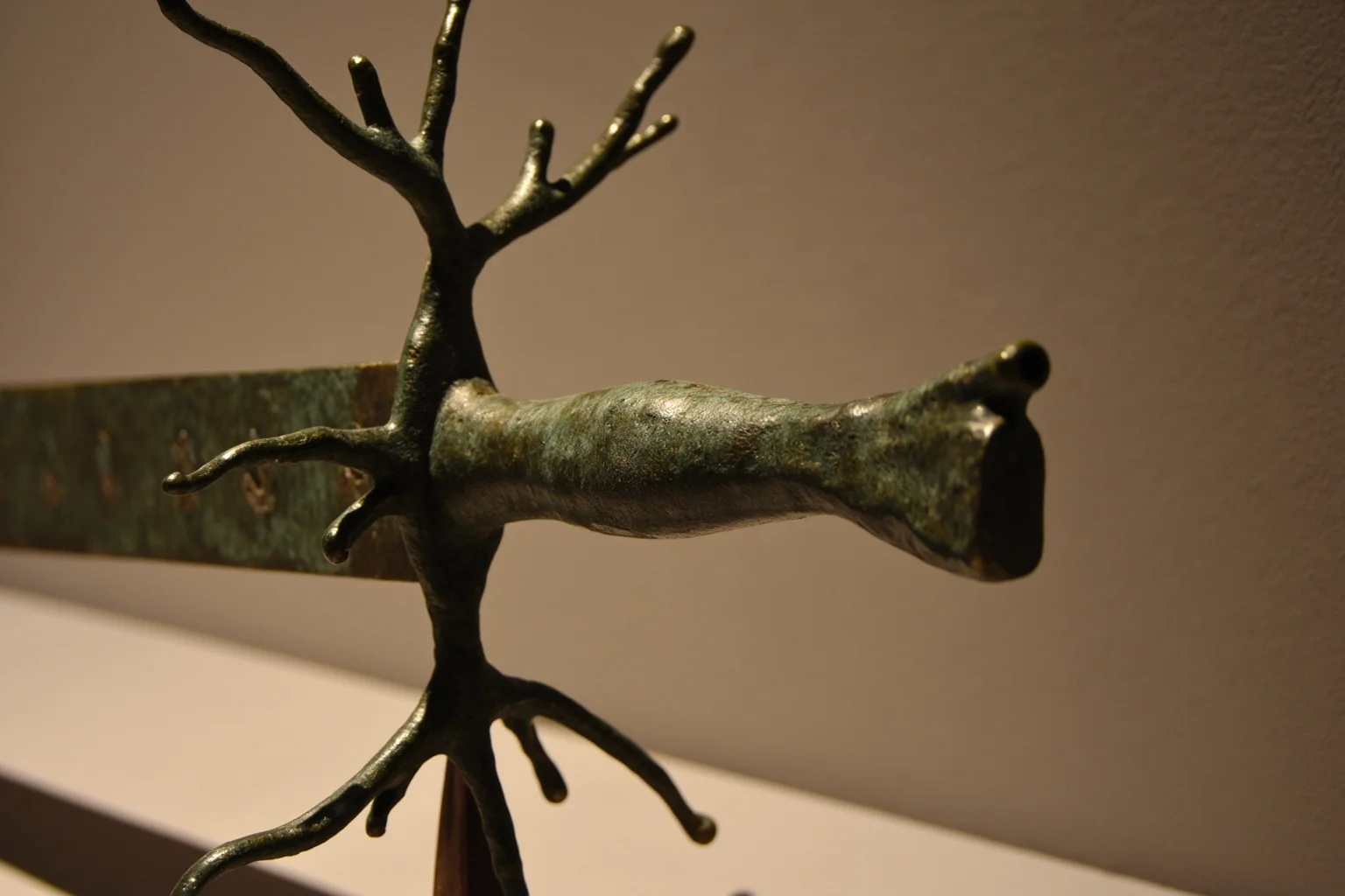 An ancient bronze ceremonial sword with multiple branch-like blade projections, shrine setting
