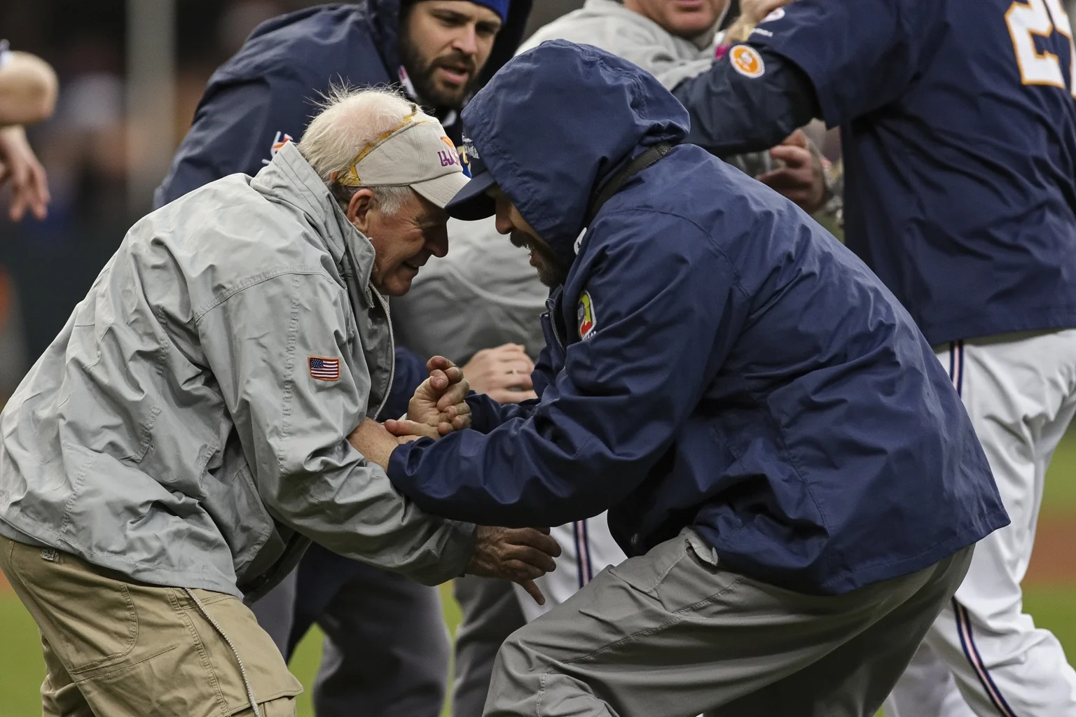 Biggest Brawls In Baseball History 13 An elderly baseball coach in a windbreaker being gently pushed down during a benches-clearing scrum on the infield