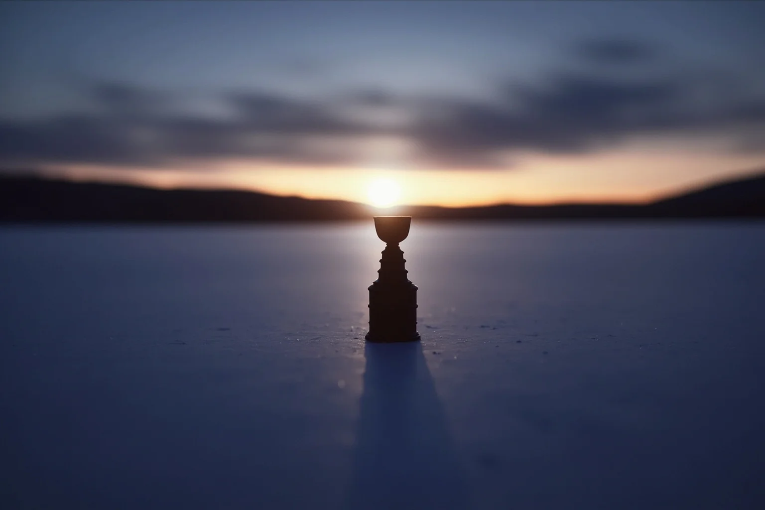 Longest Championship Droughts In Sport History 17 An empty Stanley-Cup-shaped trophy silhouette on a frozen pond at dusk, symbolic illustration, no logos