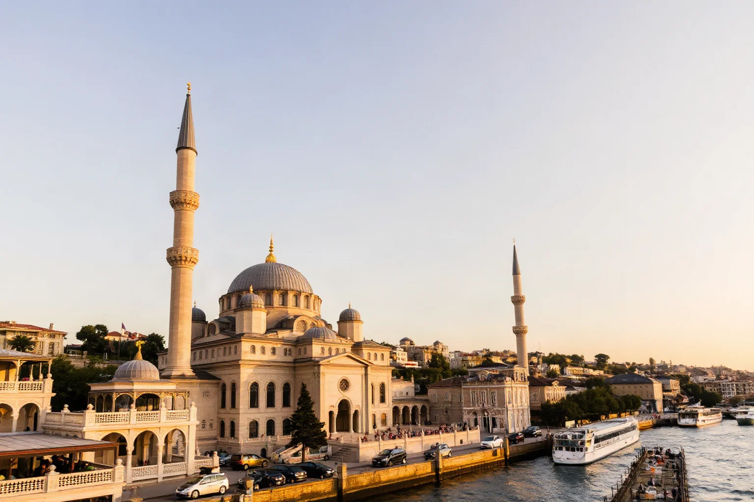 An grand Ottoman-style mosque with tall minarets overlooking a busy Bosphorus waterway