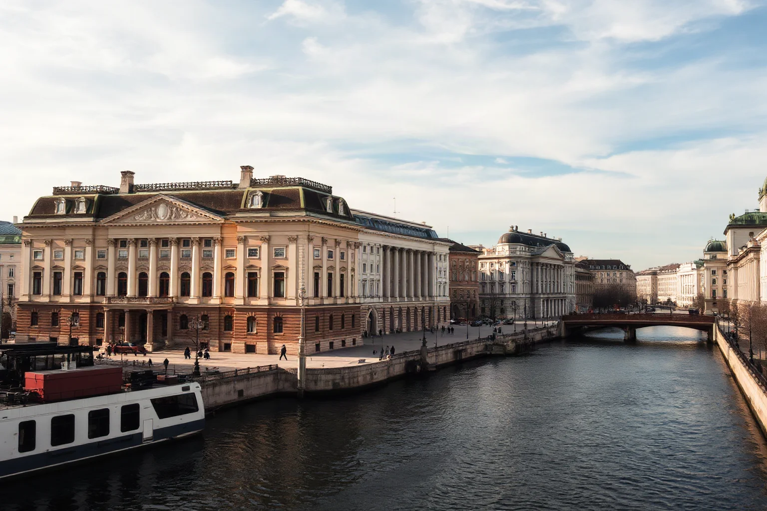 An old European city with grand Neoclassical buildings and canals, evoking pre-war Leningrad's architecture
