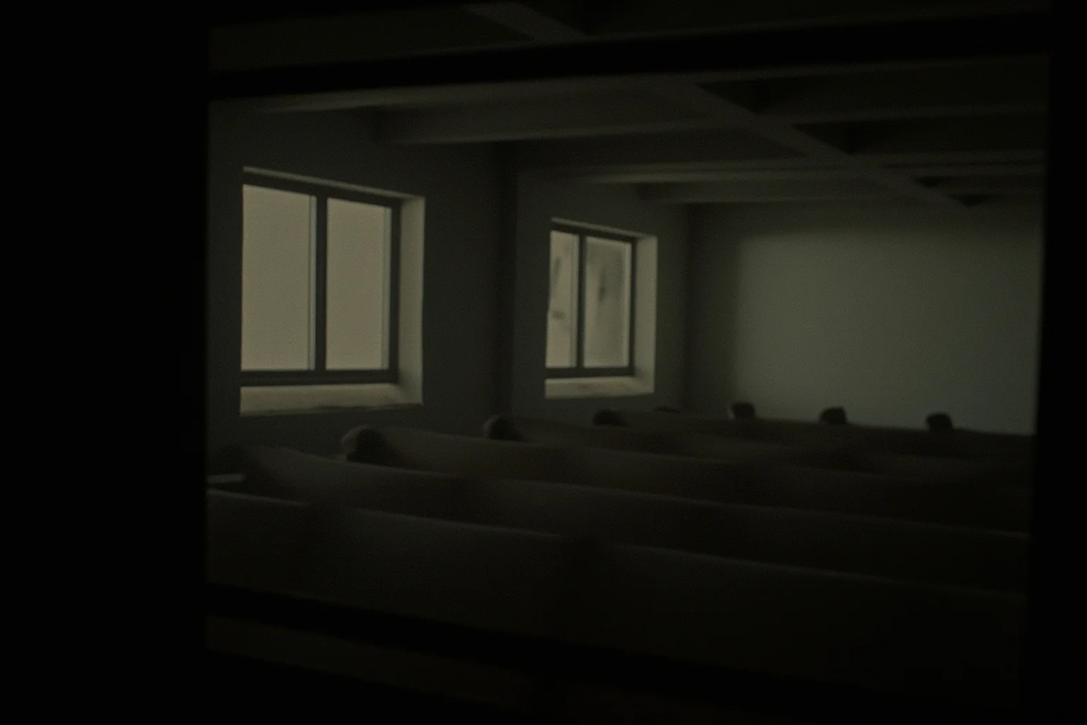 25 Disturbing Last Words By Notorious Criminals 17 An old gas chamber viewing window from a witness room, empty chairs facing forward, eerie stillness