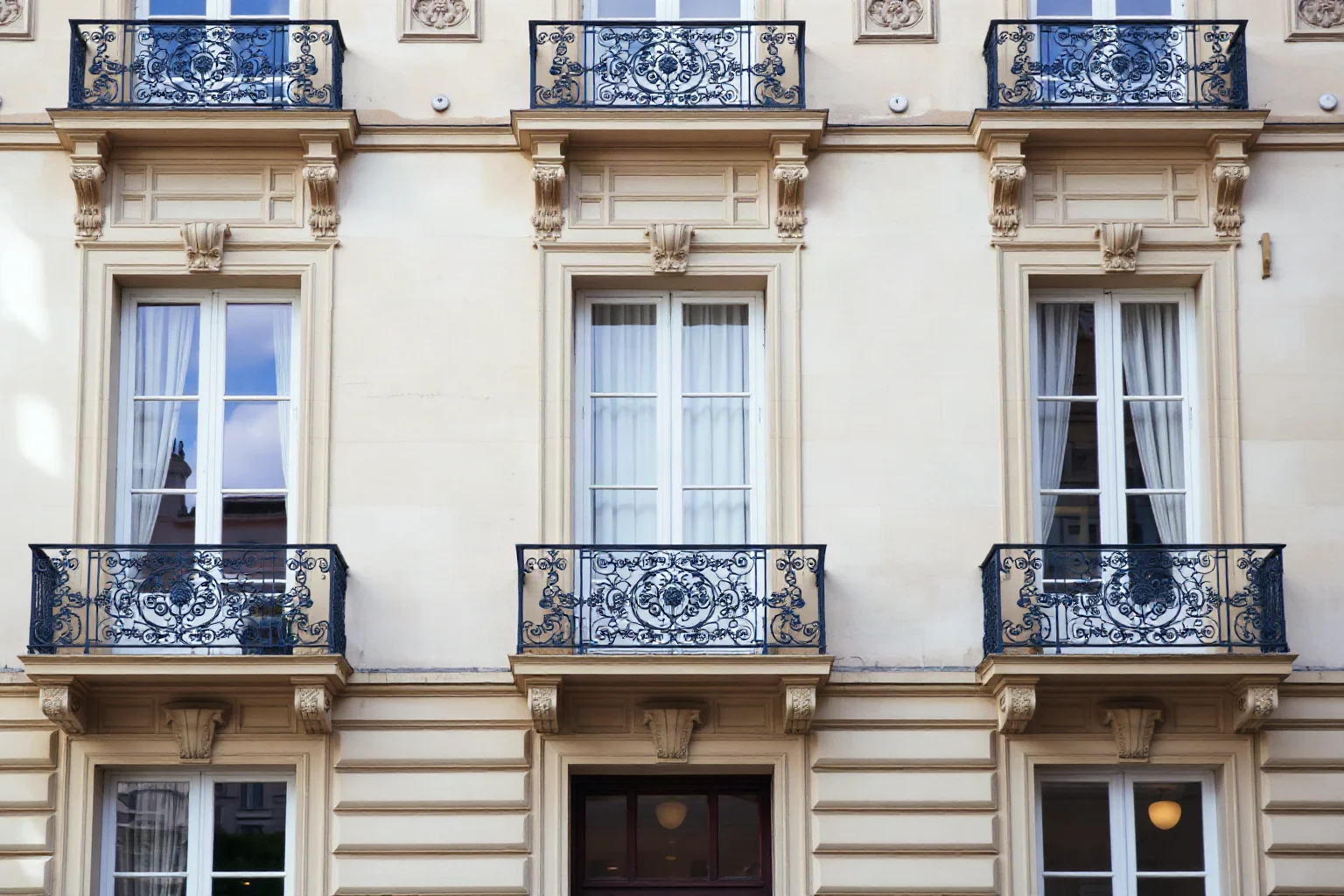 An ornate 19th-century Parisian bank building facade with wrought-iron balconies