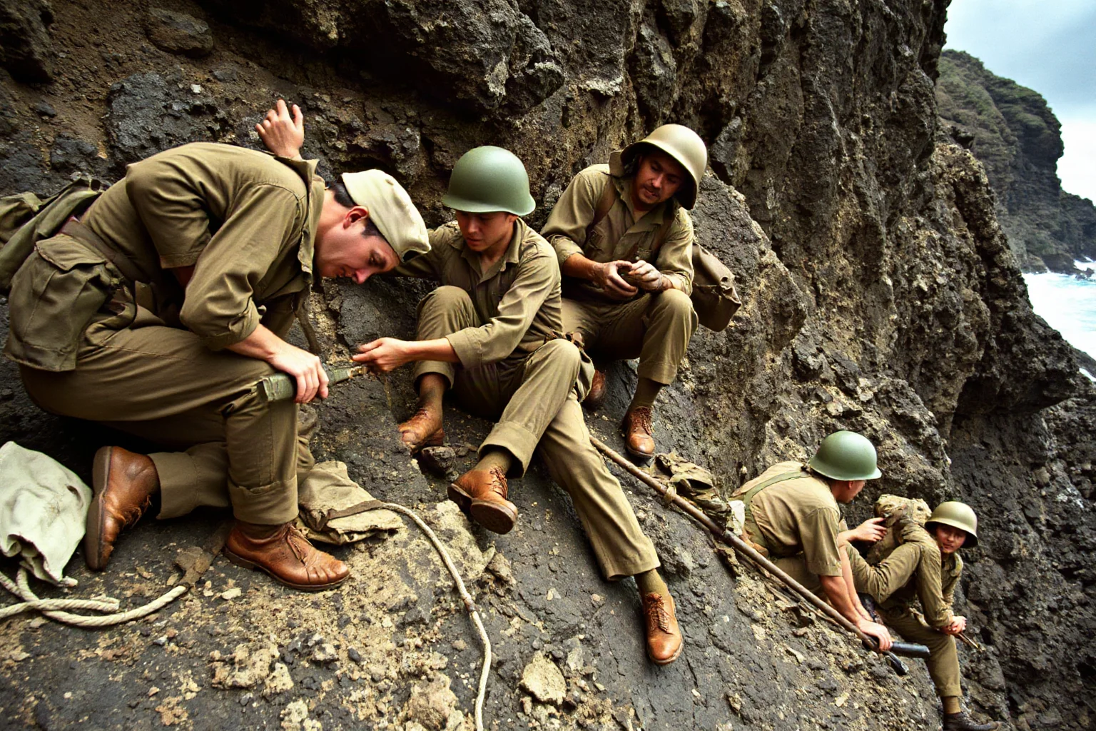 An unarmed medic in World War II uniform tending to wounded soldiers under fire on a rocky cliff face during Pacific combat