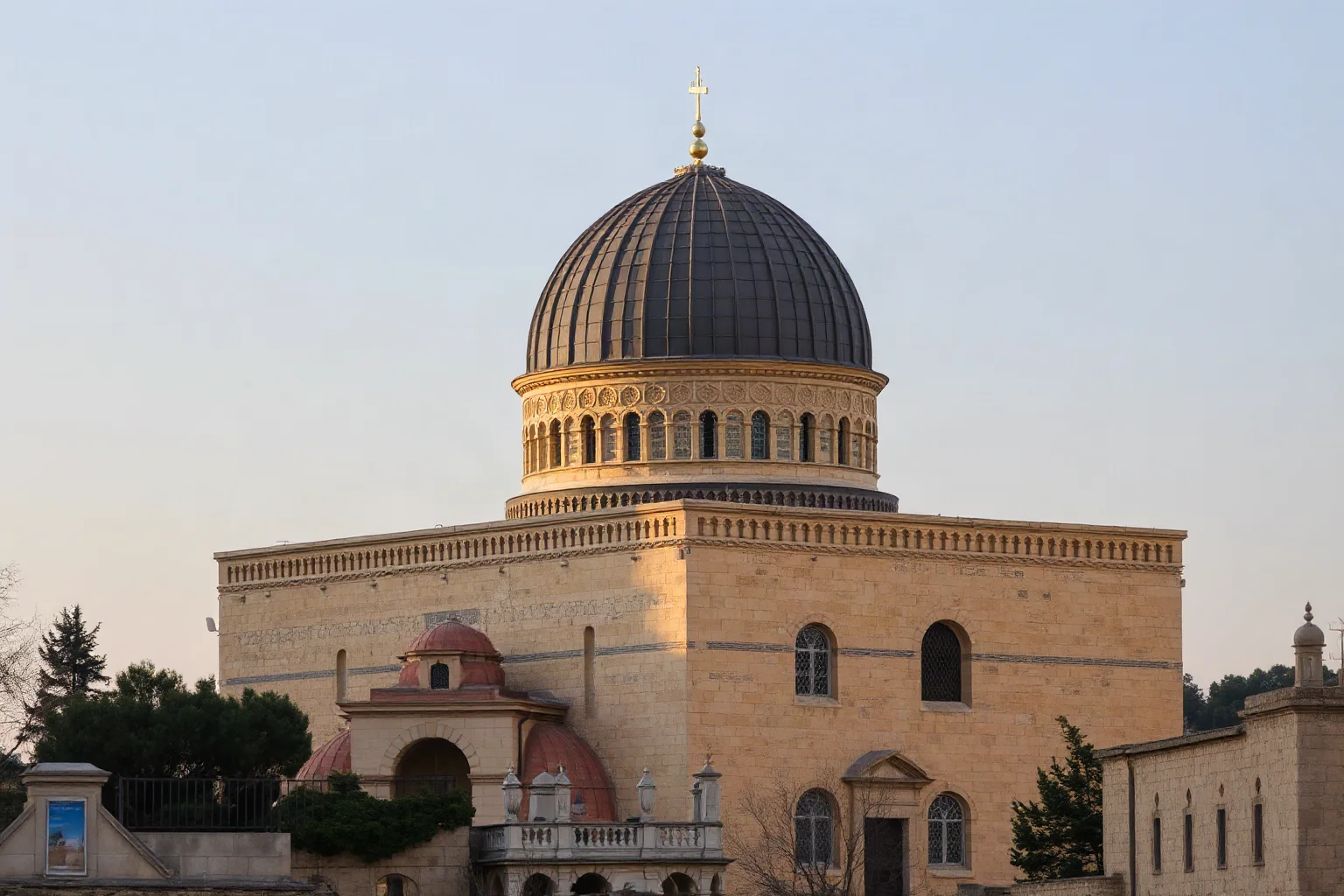 Ancient domed church with layered stone architecture in Jerusalem's old city, evening light, historic wide shot