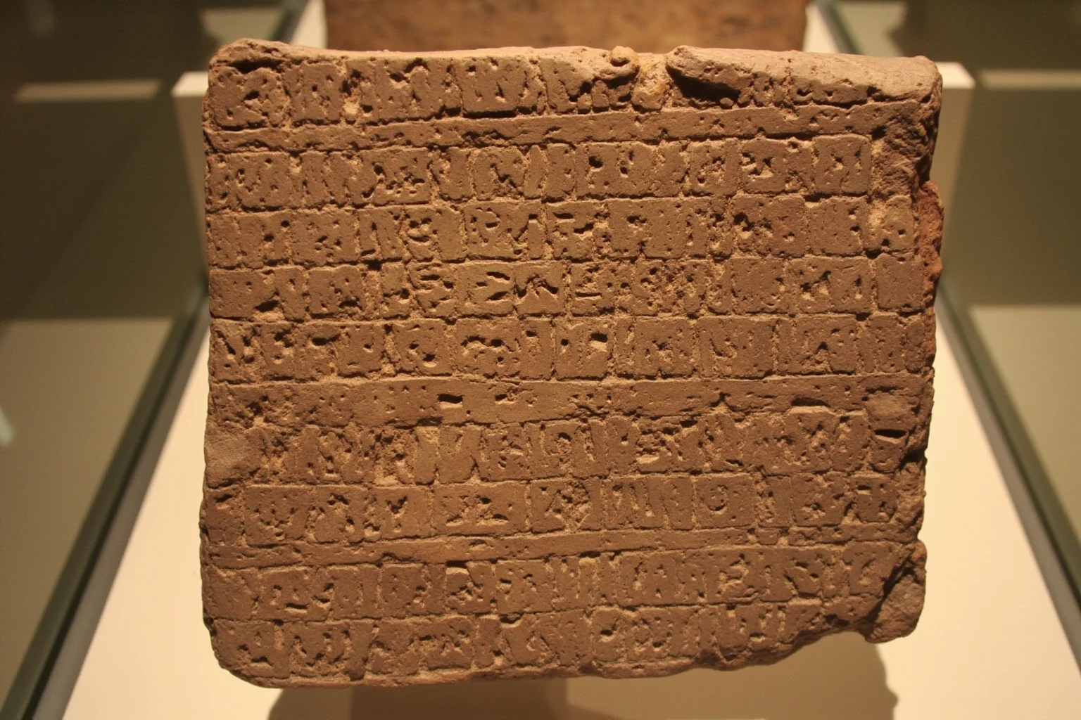 Ancient Sumerian clay tablet with cuneiform writing, archaeological artifact photography