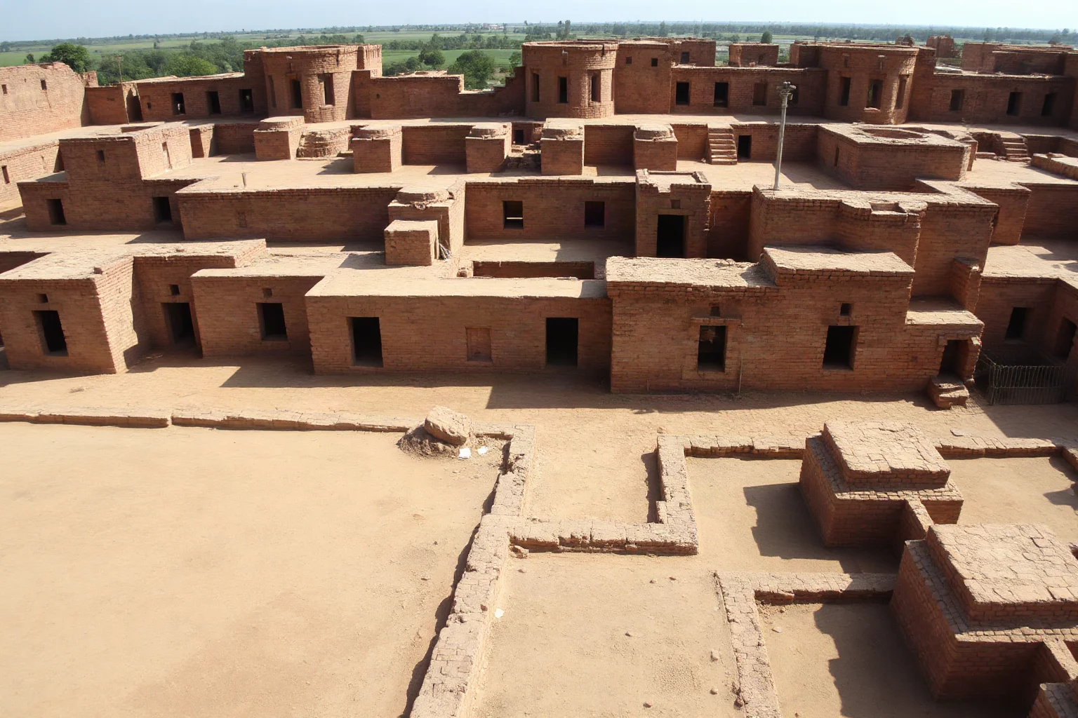 Archaeological site of Mohenjo-daro showing geometric urban grid layout with well-preserved ancient brick buildings and drainage systems
