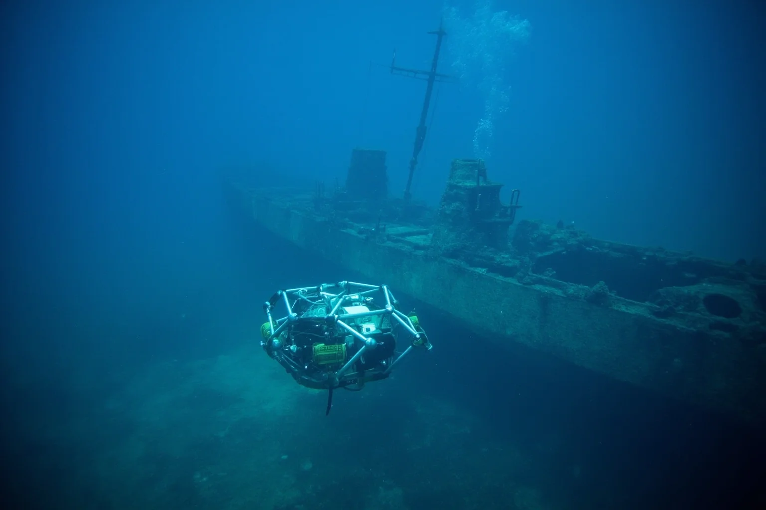 22 Coolest Underwater Discoveries Made Throughout History 13 Autonomous underwater vehicle scanning a sunken WWII-era warship wreck in deep blue water