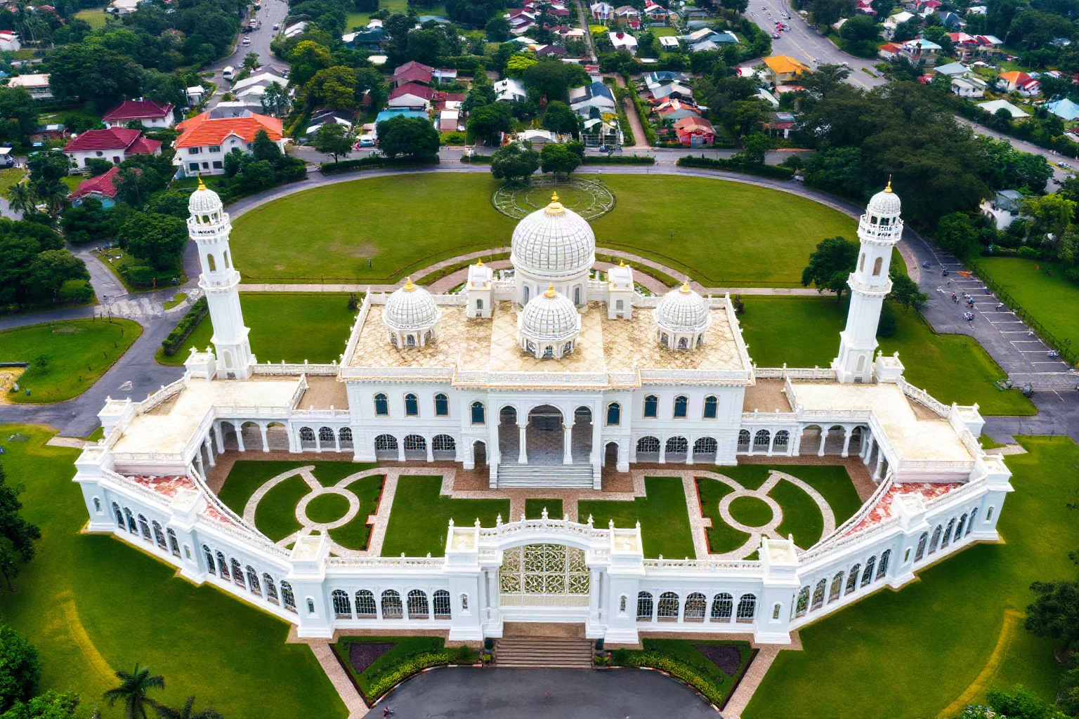 Aerial view of Istana Nurul Iman palace in Brunei, a massive white residential palace with Islamic architectural features and manicured grounds