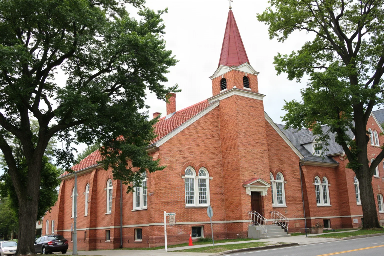 Brick colonial church with a modest steeple and Swedish colonial architectural details in an old city neighborhood