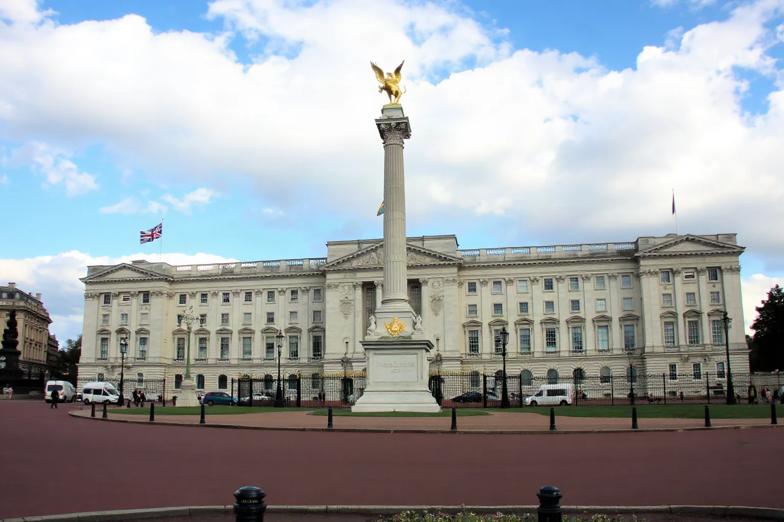 Buckingham Palace in London's front facade with the Victoria Monument visible in the foreground