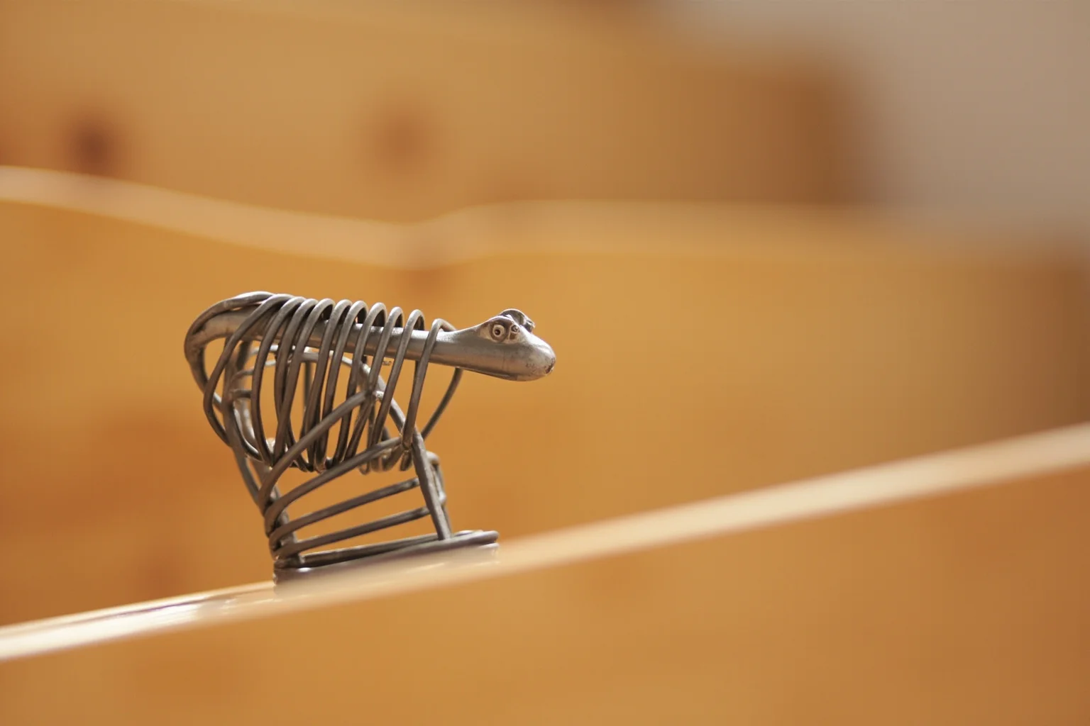 Biggest Fads Throughout American History 14 Close-up of a metal Slinky toy walking down a set of wooden stairs