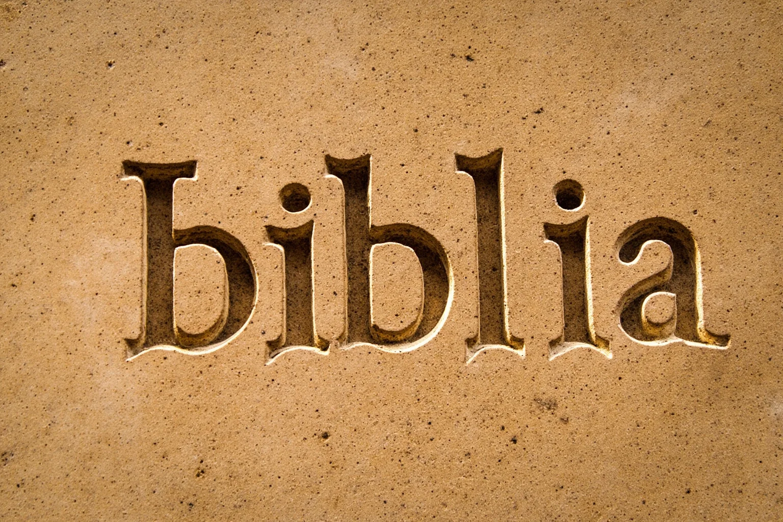 Close-up of the Greek word 'biblia' engraved in ancient stone lettering
