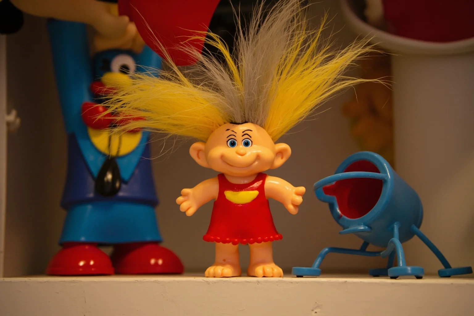 Biggest Fads Throughout American History 20 Colorful troll doll figurine with wild hair standing on a toy shelf, 1960s style