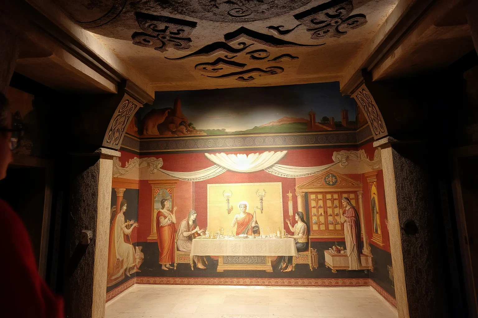 Etruscan painted tomb interior with banquet scene murals in ancient Italy