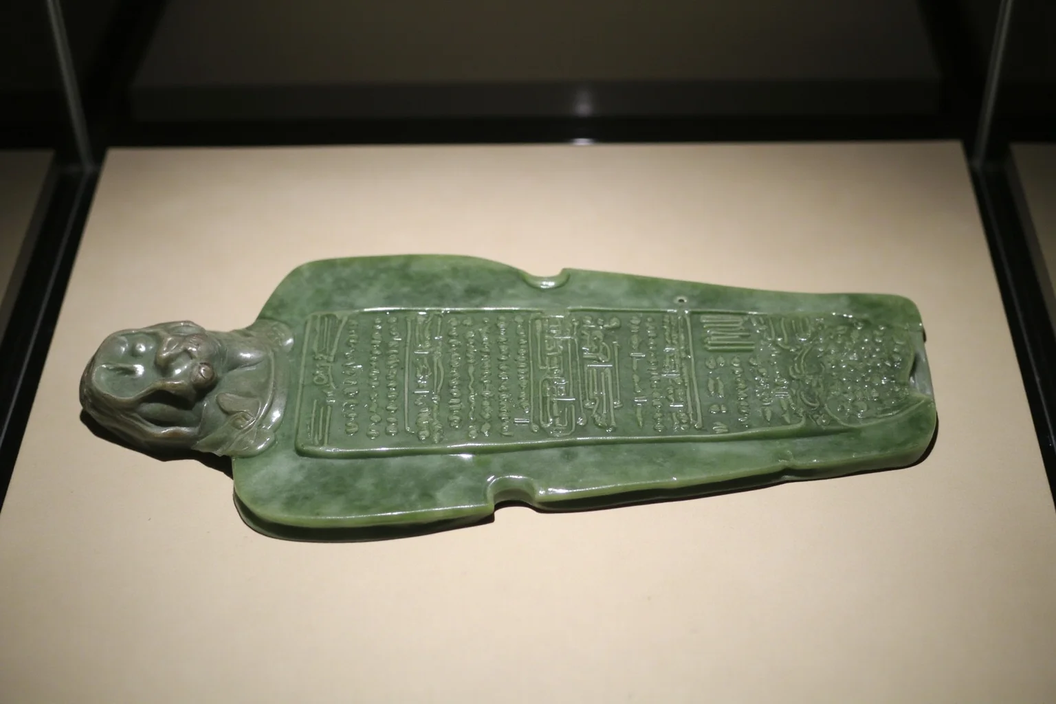 Full-body jade plaque burial suit laid out in a museum glass case
