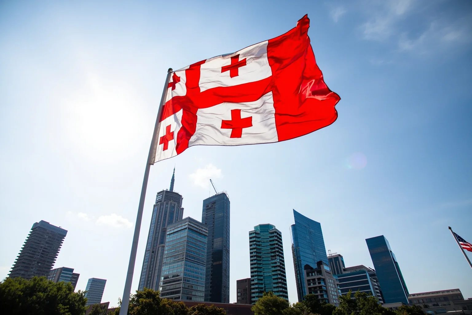 Georgia's five-cross flag flying above a modern city skyline, symbolizing recent official readoption