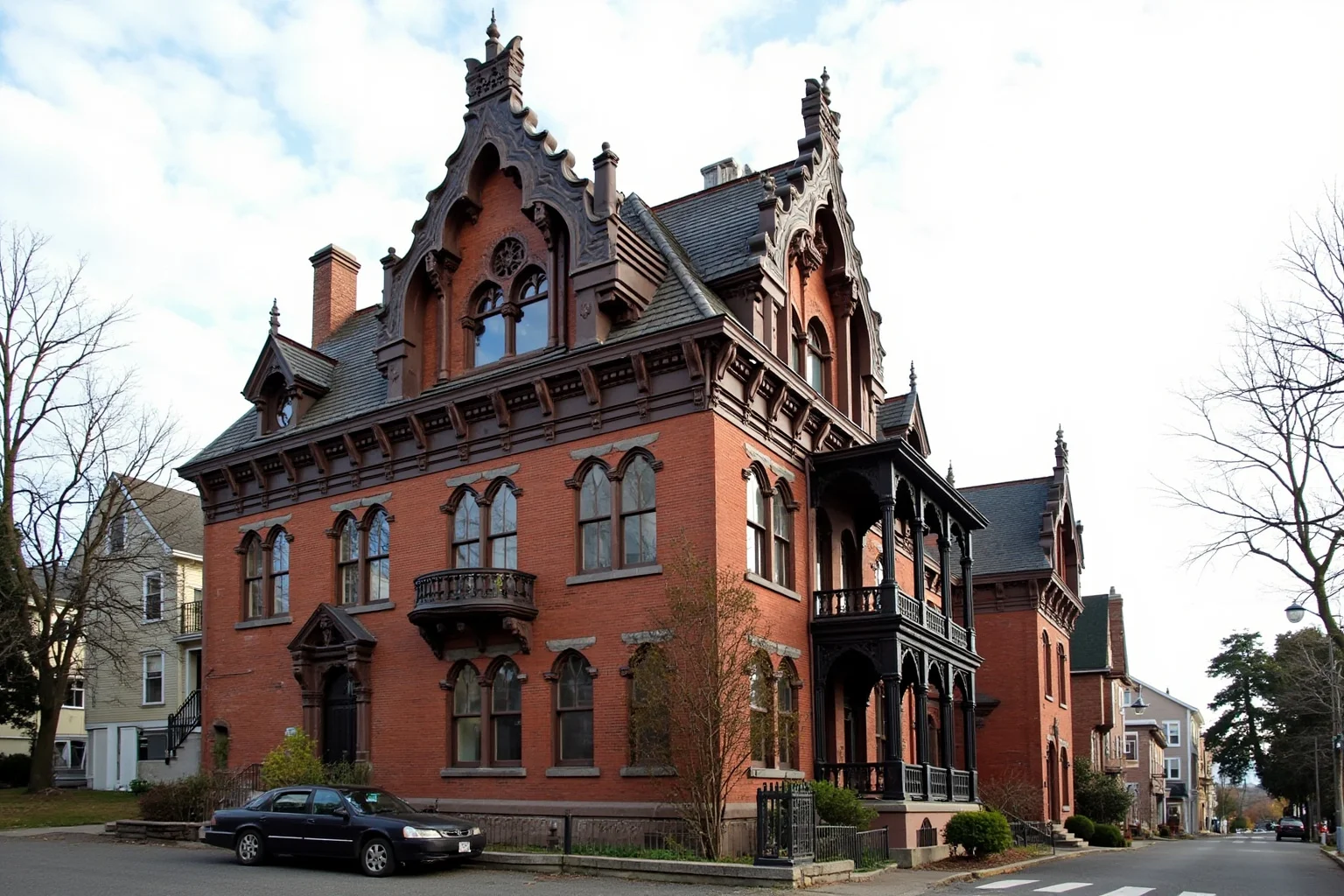 25 Famous American Historical Homes You Can Still Visit Today 16 Gothic Revival brick house with steep gables and ornate wooden trim in a New England town