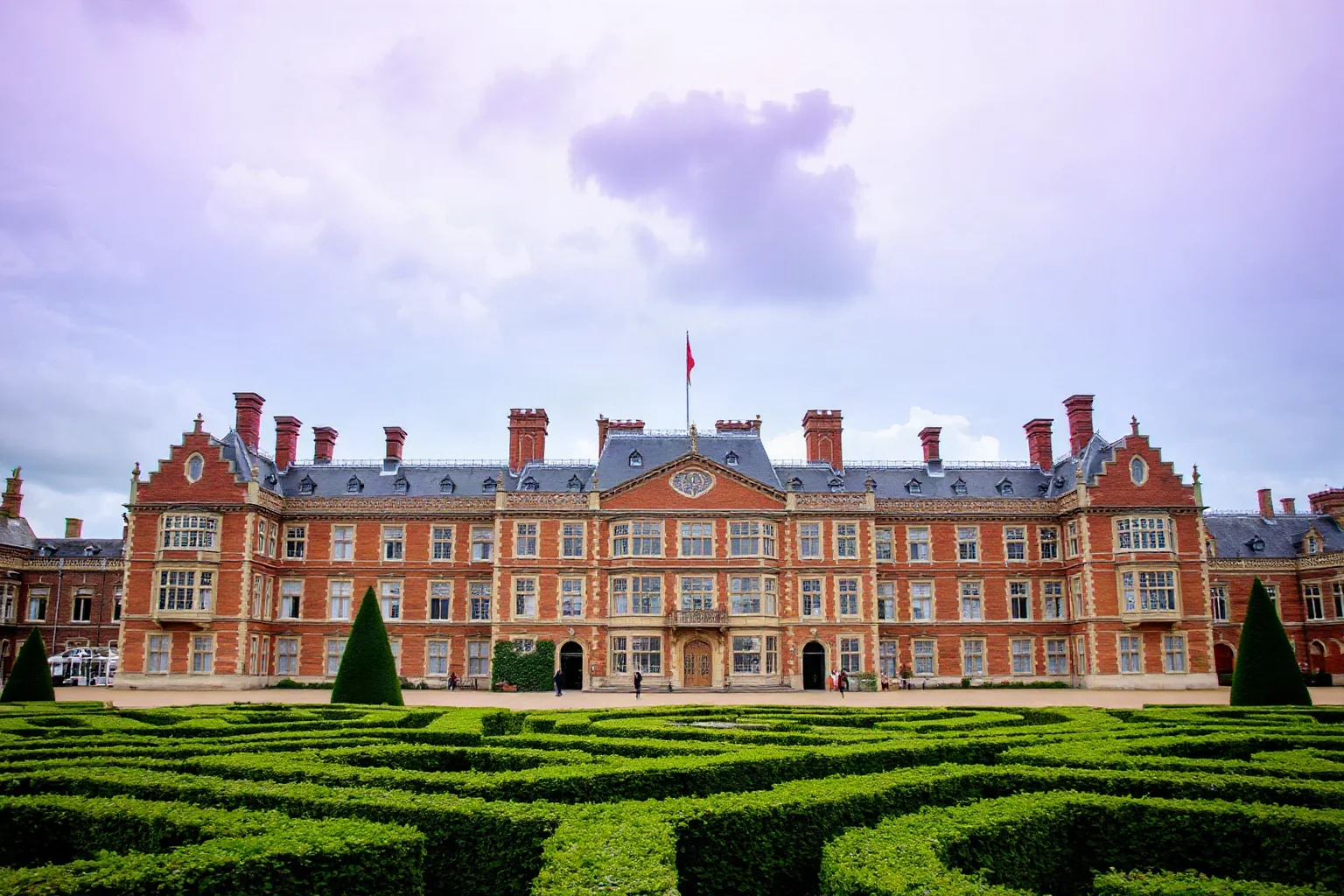 Hampton Court Palace with its Tudor architecture, red brick facade, and famous hedge maze