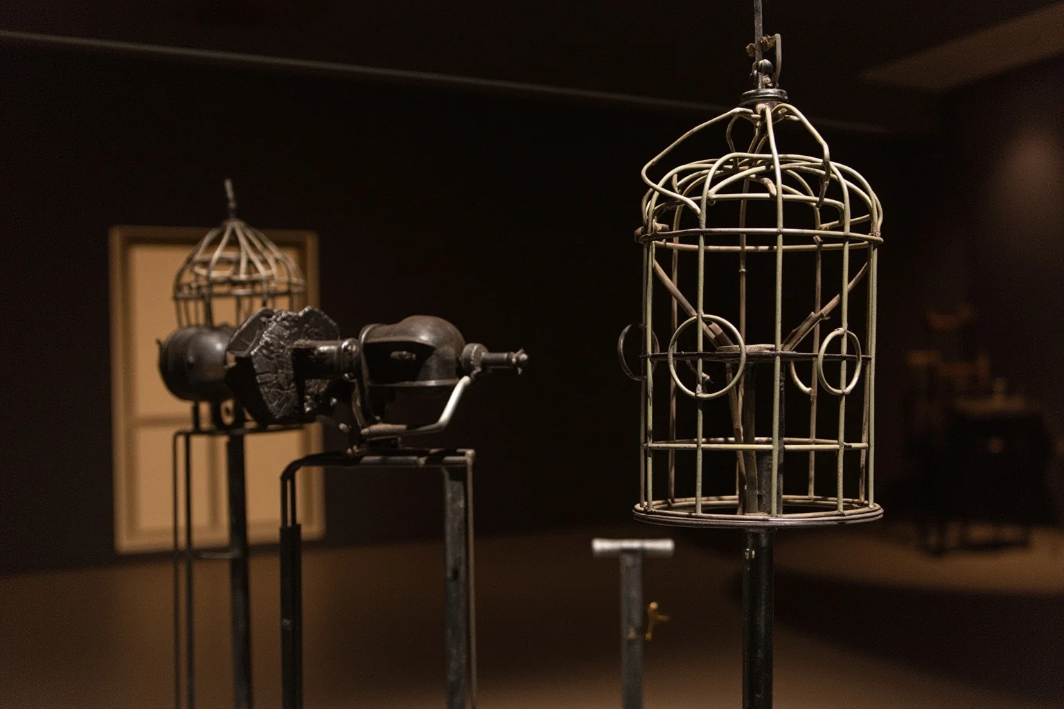 The Worst Inventions of All Time, Ranked 15 Illustration of an old iron head-cage device displayed in a dim historical museum setting
