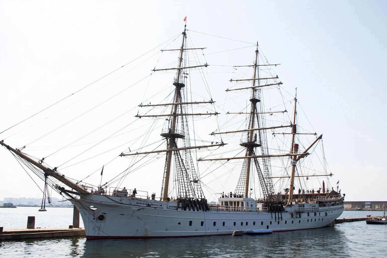 The Longest-Serving Warships of All Time 14 Late 19th-century three-masted steel training frigate with white hull, docked in a South American harbor