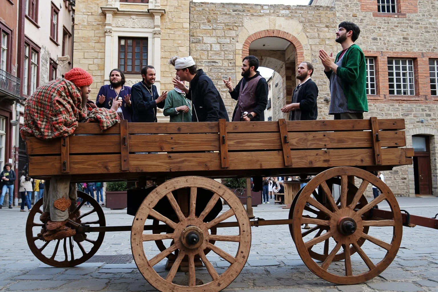 Medieval actors performing a biblical mystery play on a wooden pageant wagon in a town street