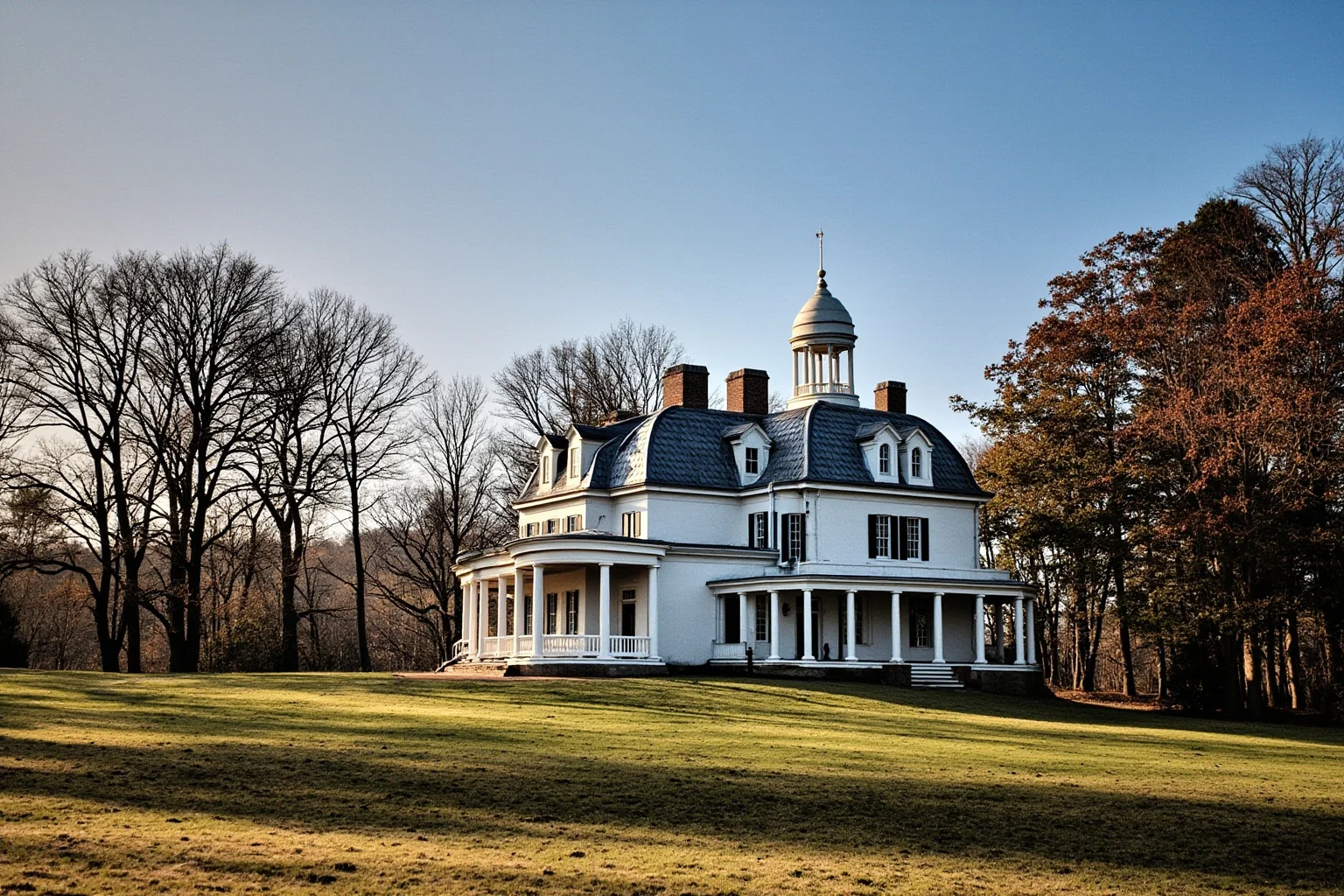 25 Famous American Historical Homes You Can Still Visit Today 3 Neoclassical domed mansion on a wooded hilltop with a columned portico, in the style of an early American plantation home