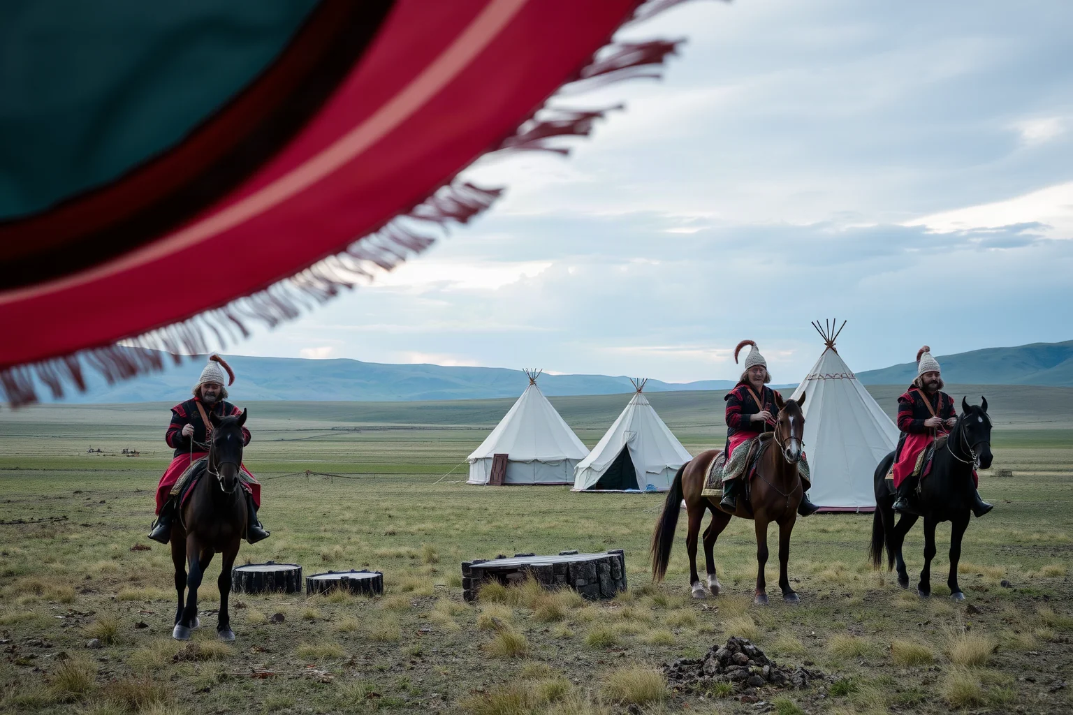 Nomadic Xiongnu horsemen camp on the Mongolian steppe with felt tents in the background