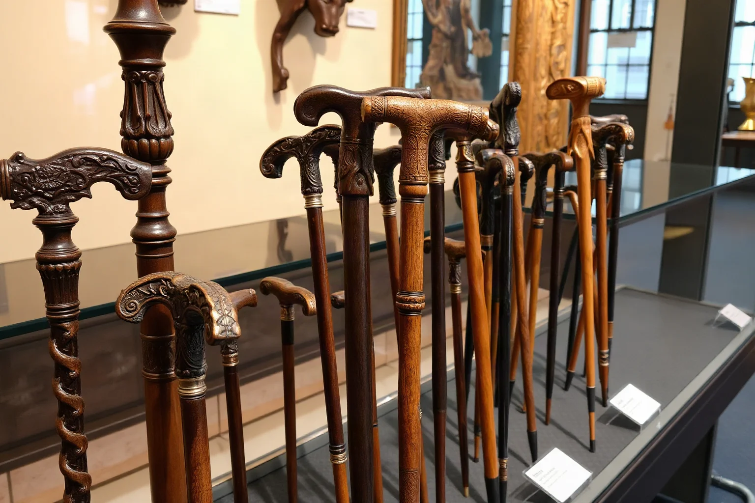 Ornate carved wooden walking canes and staffs laid out on a museum display, illustrative style