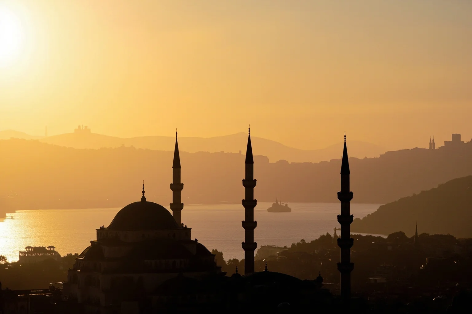Ottoman domed mosque skyline with minarets overlooking the Bosphorus at sunset
