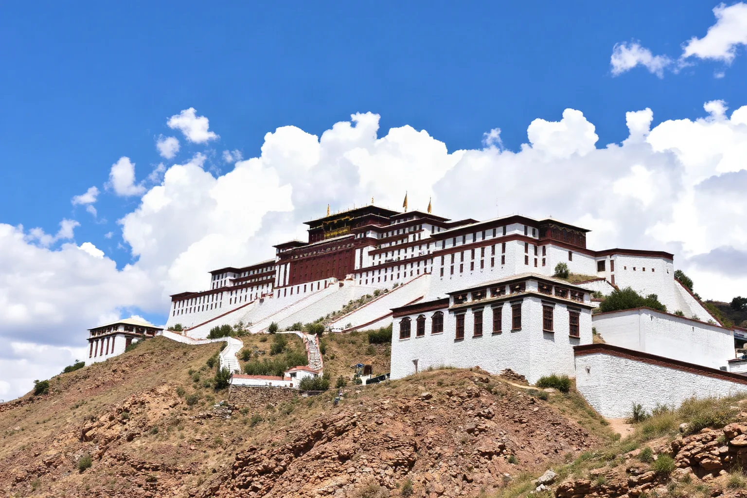 Potala Palace perched on Red Hill in Lhasa, Tibet, at high altitude with the white and red stone fortress-palace architecture