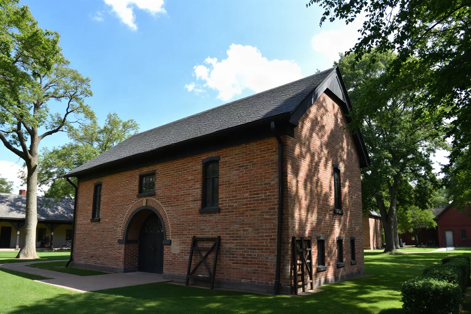 Reconstructed 17th-century brick chapel with steep gabled roof in a colonial American settlement museum setting