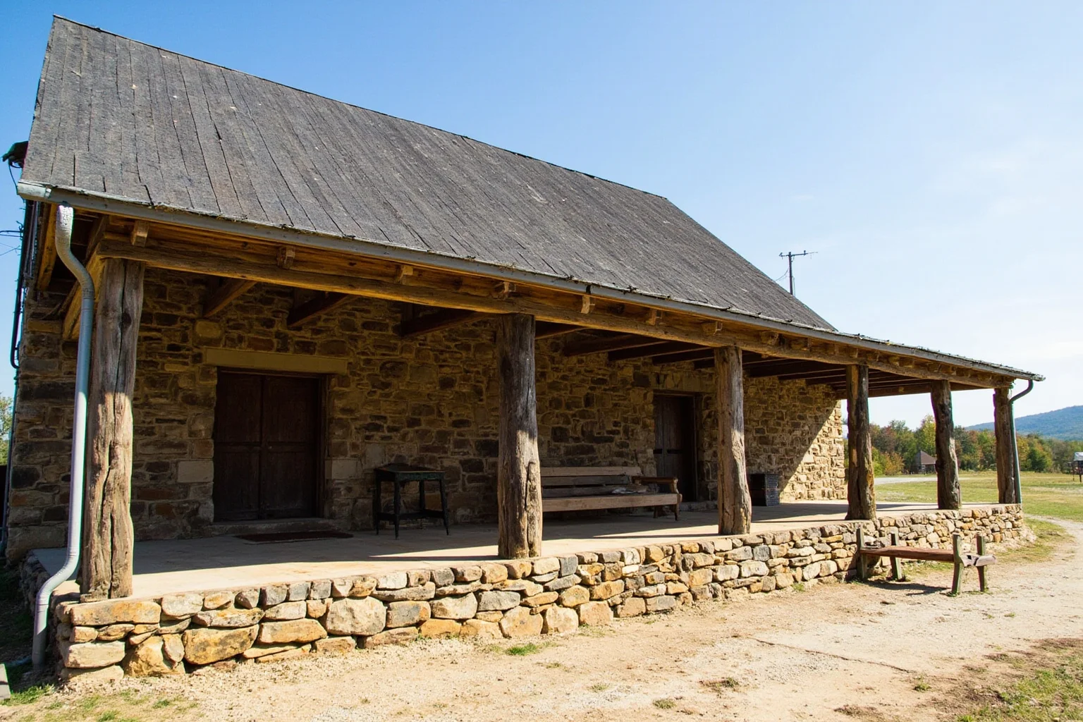 Rustic 18th-century stone and wood tavern building with a covered porch, Kentucky frontier setting