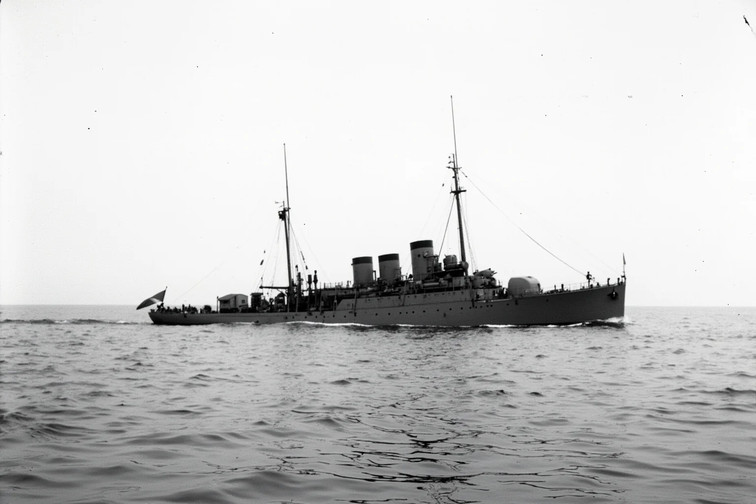 The Longest-Serving Warships of All Time 7 Small early-20th-century steel minelayer ship at sea, modest size, gray hull, historic wartime atmosphere