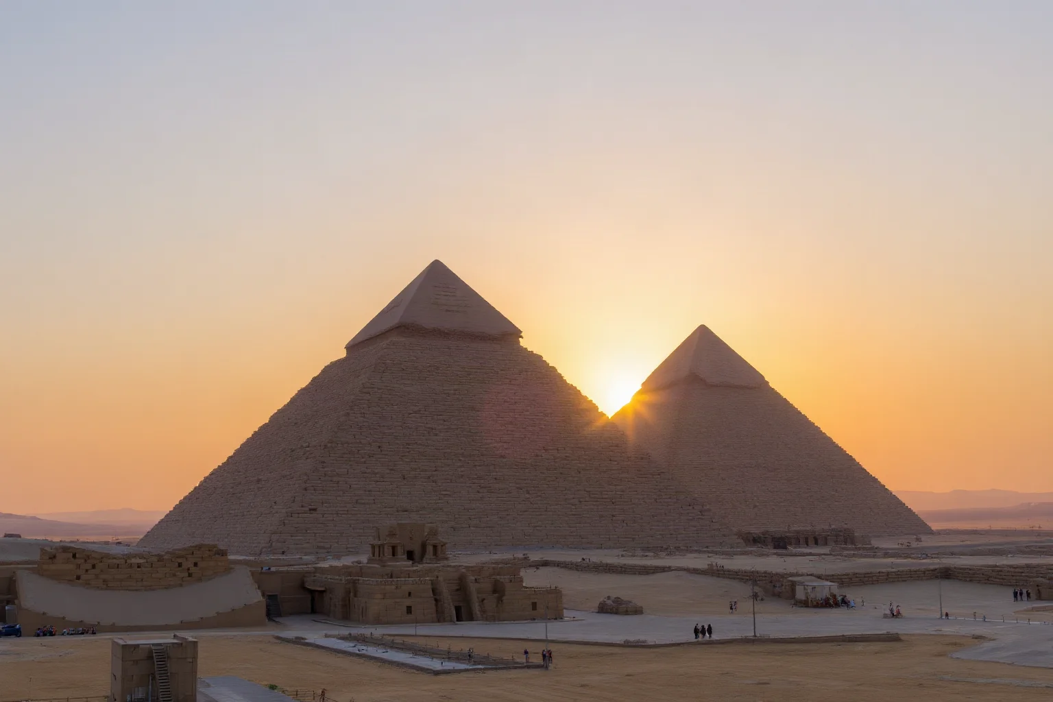 The Great Pyramid of Giza at sunset, showcasing its massive stone blocks, precise geometry, and scale against the desert landscape