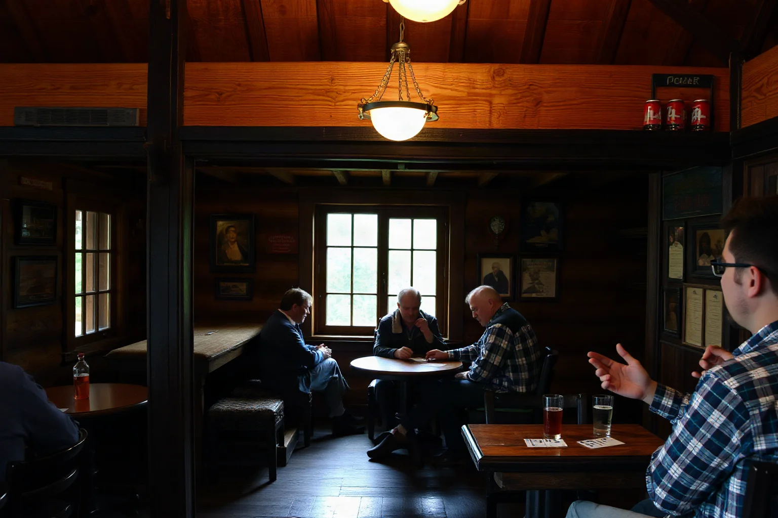 The interior of a modest wooden saloon with card players and patrons talking calmly over drinks