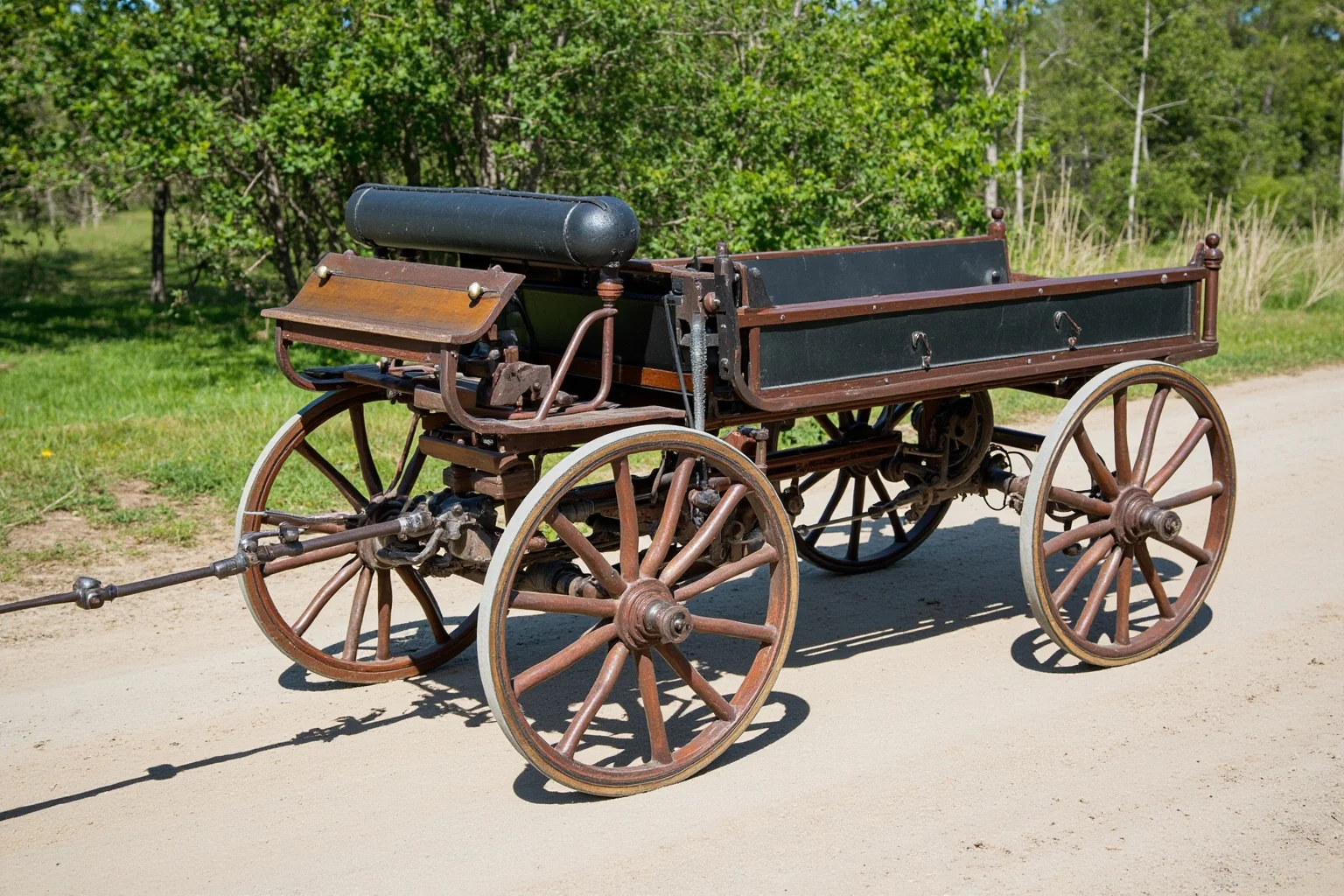 A late-1800s horseless carriage with a simple one-cylinder engine, wooden wheels, and open bench seating on a dirt road