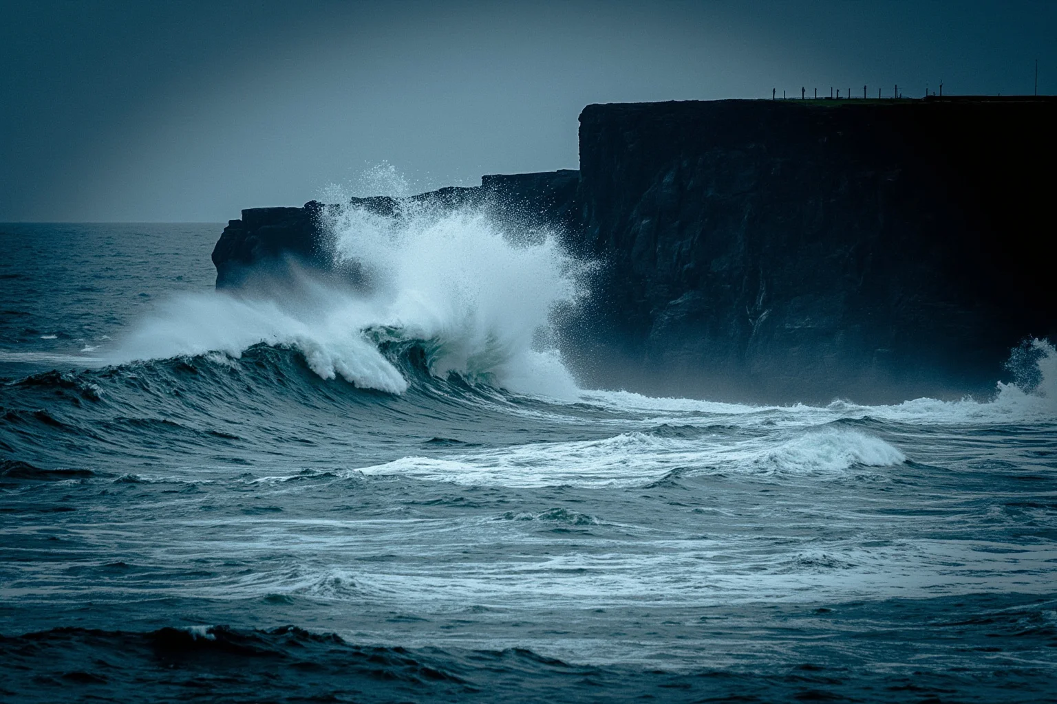 Turbulent dark ocean waves crashing against tall sea cliffs during a storm