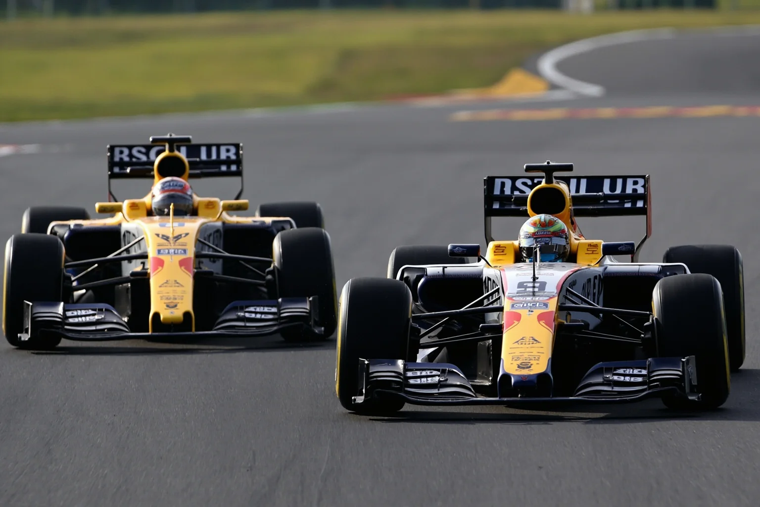 26 of History's Most Famous Rivalries 16 Two Formula 1 race cars in rival liveries battling side by side on a track