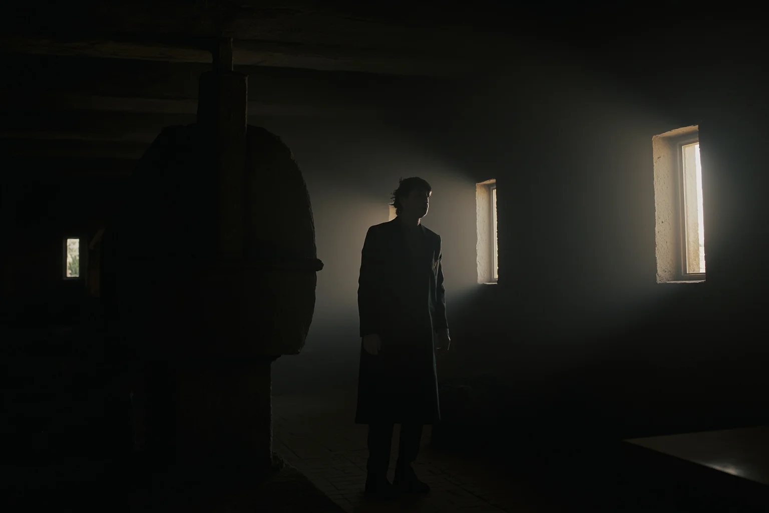 Two shadowy figures in a dim stone lighthouse room, tense atmosphere, no visible faces