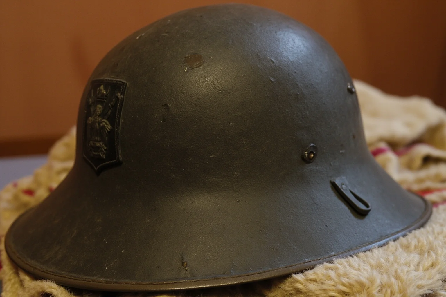 Best Nonfiction Books About WWI: The 25 Best WWI and WWII Reads 20 Vintage paratrooper helmet and insignia resting on a folded wool blanket